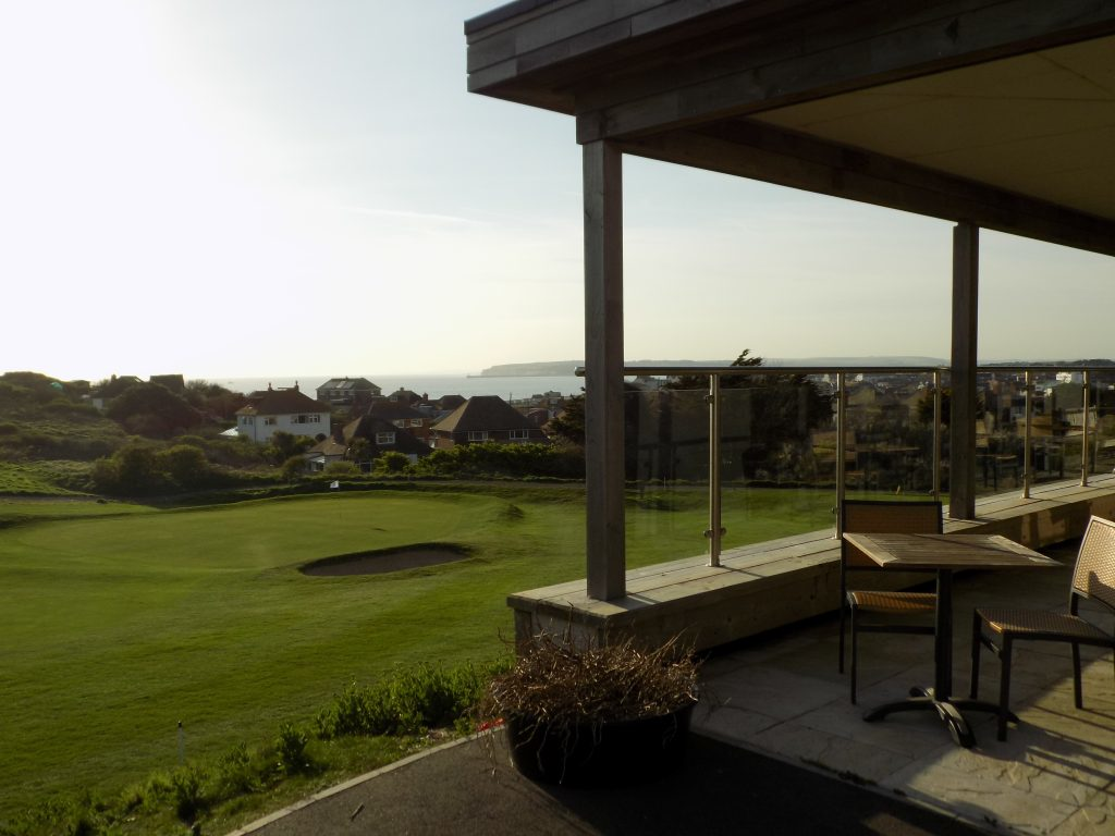 Outdoor tables at The View, with Seaford Bay beyond