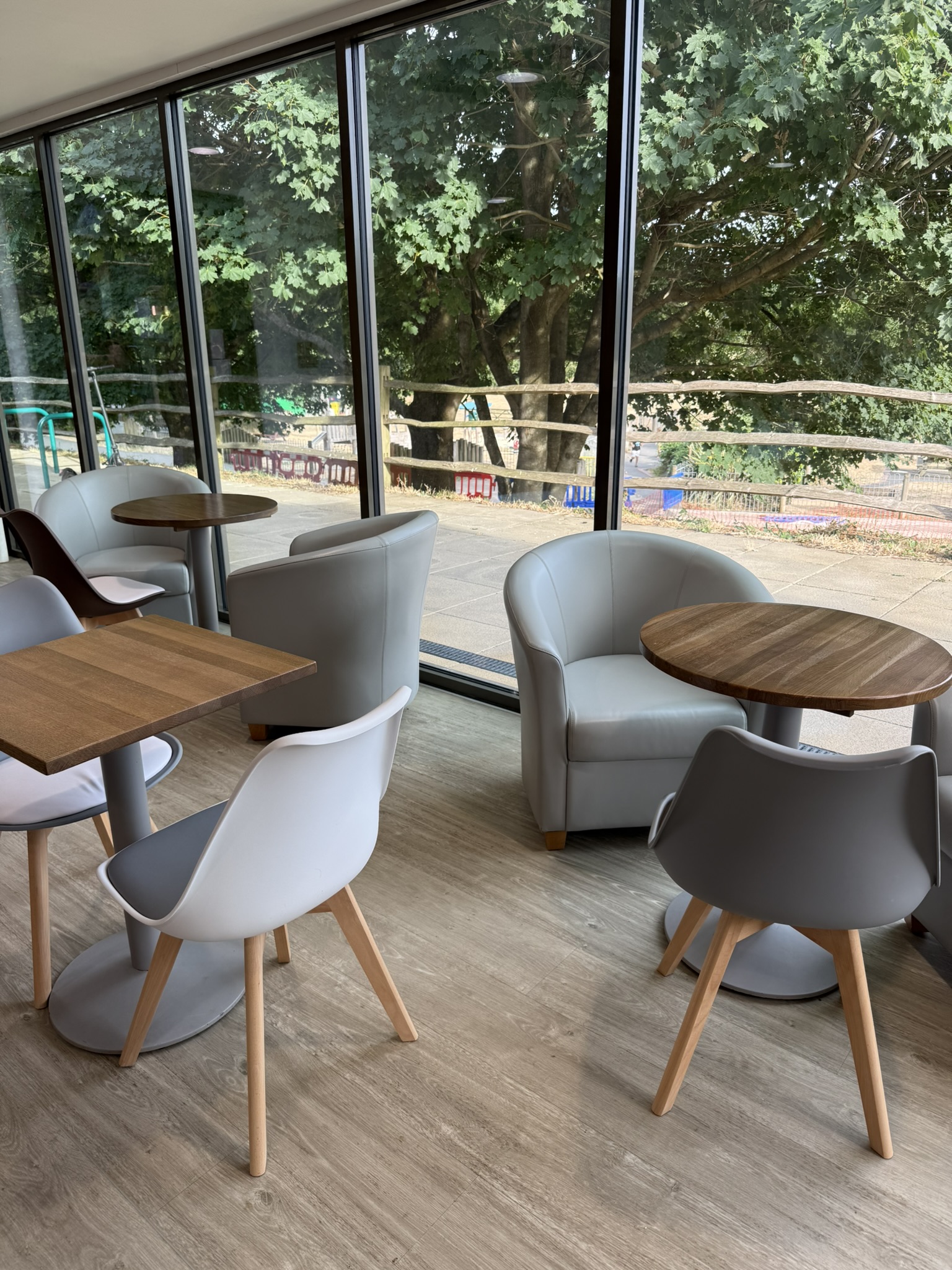 Tables and seating beside the large windows at Malling Community Café